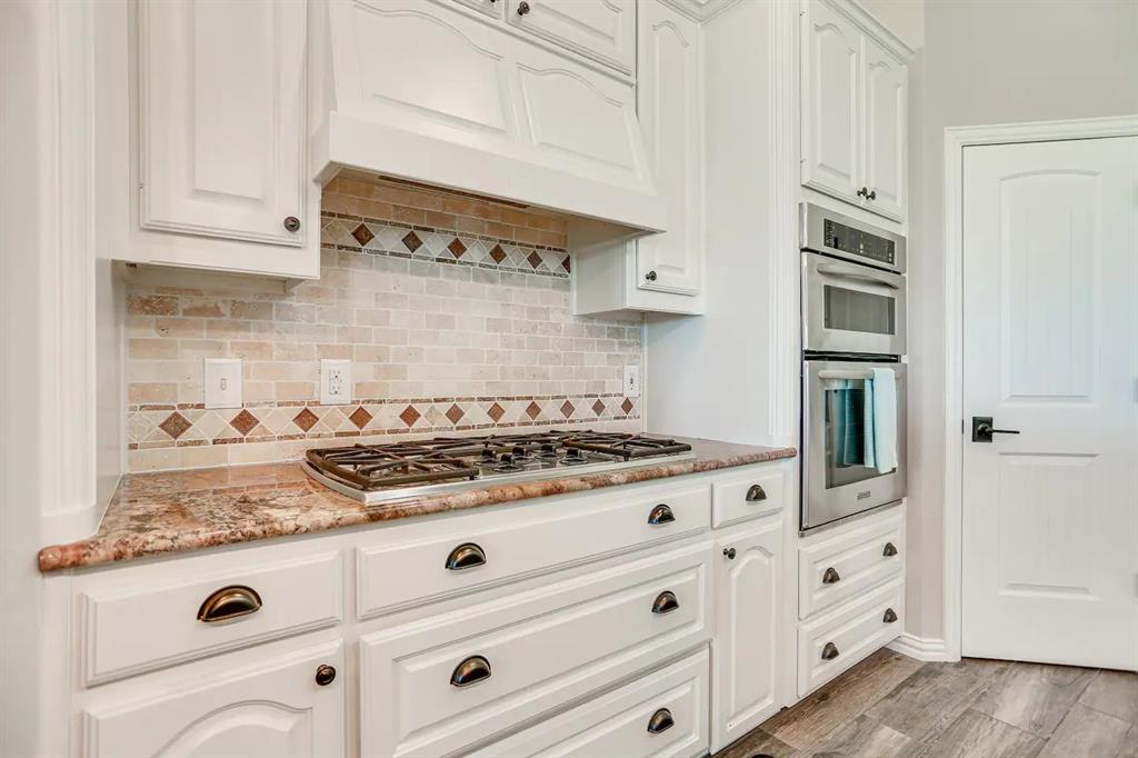 2045 Weston Road McKinney, TX 75071 - Photo 12 of 40 a white stove top oven sitting inside of a kitchen