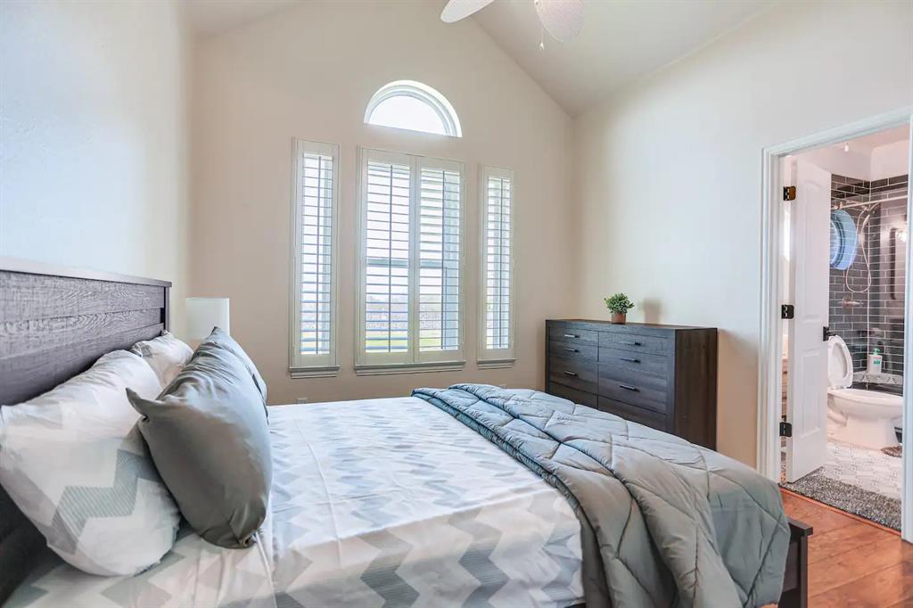 2045 Weston Road McKinney, TX 75071 - Photo 13 of 40 a bedroom with a bed and a large mirror