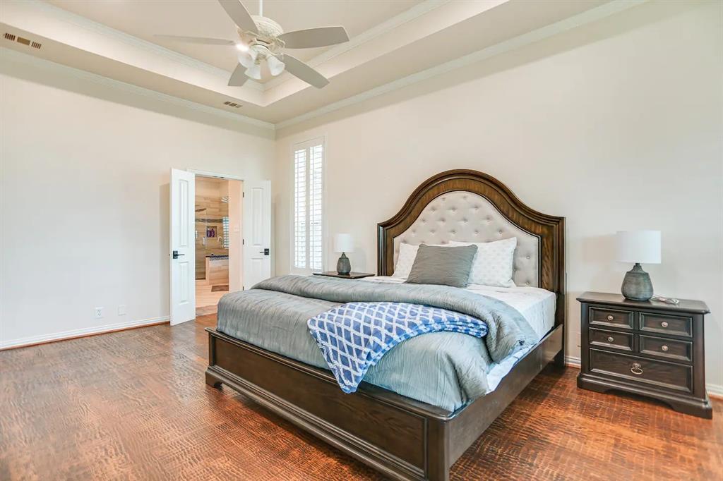 2045 Weston Road McKinney, TX 75071 - Photo 15 of 40 a bedroom with a bed and a dresser