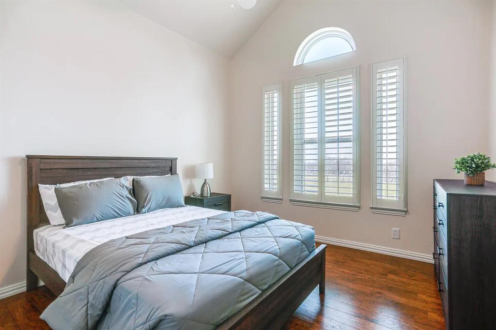 2045 Weston Road McKinney, TX 75071 - Photo 16 of 40 a bedroom with a bed and a window