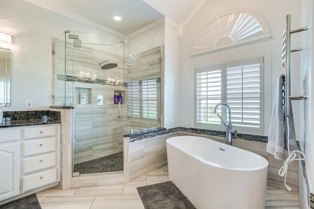 2045 Weston Road McKinney, TX 75071 - Photo 17 of 40 a bathroom with a bathtub and a sink