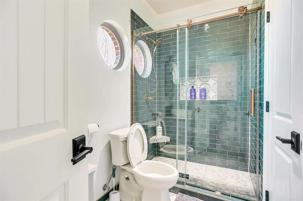 2045 Weston Road McKinney, TX 75071 - Photo 24 of 40 a bathroom with a toilet and a shower
