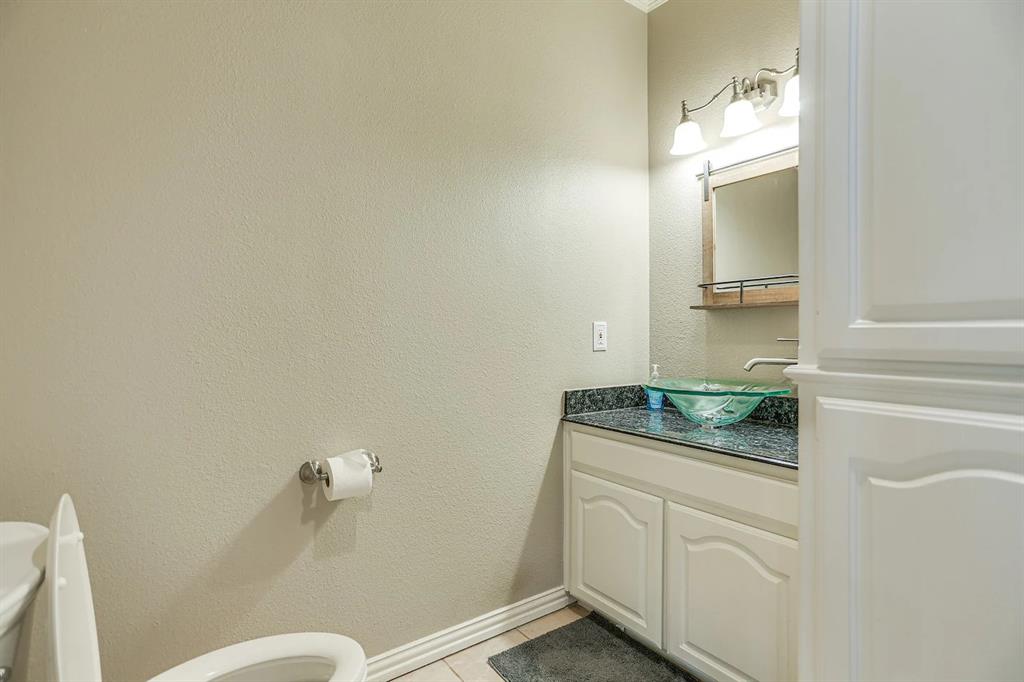 2045 Weston Road McKinney, TX 75071 - Photo 25 of 40 a bathroom with a granite countertop sink and a mirror