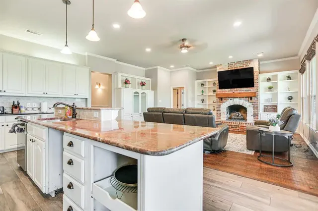 a view of living room kitchen with stainless steel appliances granite countertop living room