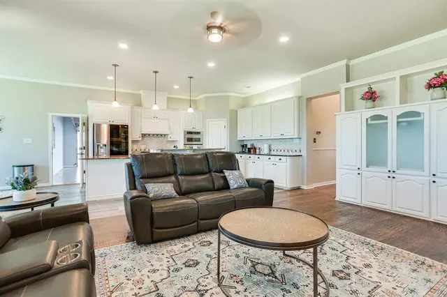 a living room with furniture and kitchen view