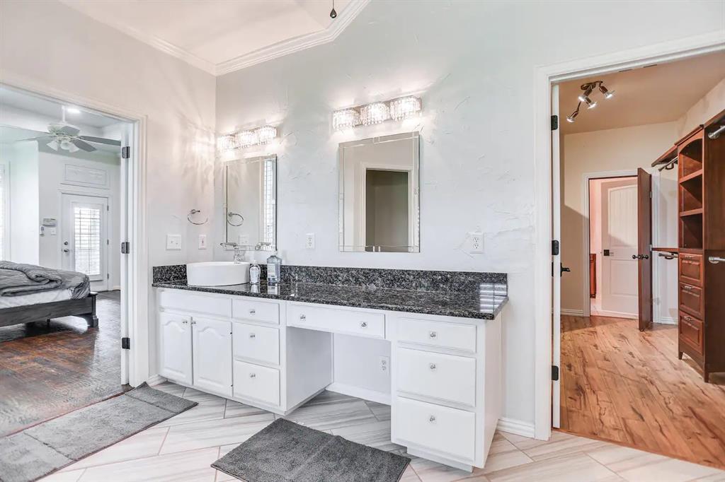 2045 Weston Road McKinney, TX 75071 - Photo 7 of 40 a spacious bathroom with a granite countertop sink a mirror and shower