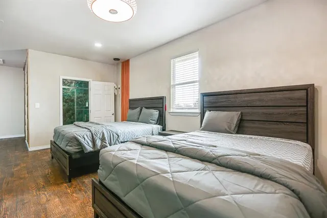 a bedroom with double bed and a large window