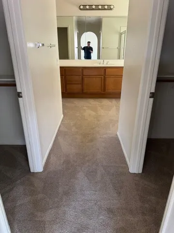 a view of a bathroom with a sink and mirror