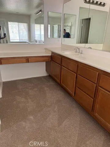 a spacious bathroom with a granite countertop sink mirror and double