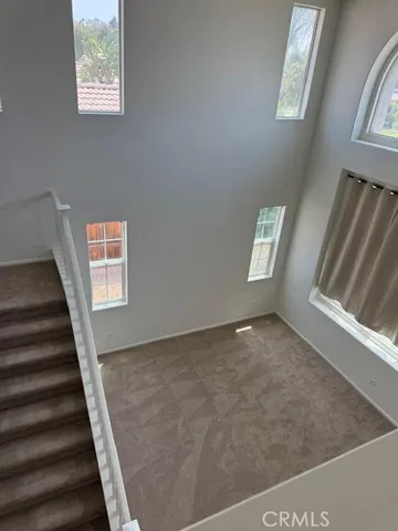 a view of an empty room with windows