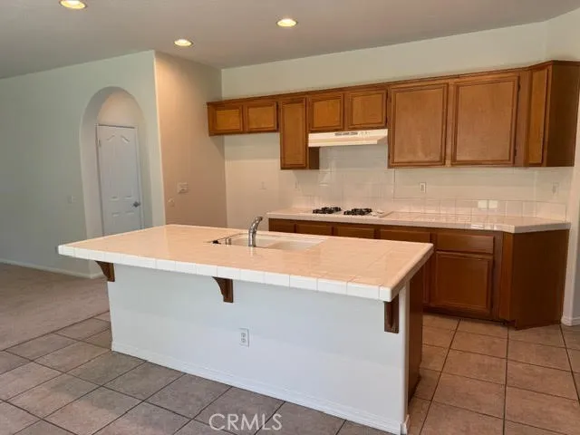 a kitchen with a sink a stove a refrigerator and cabinets