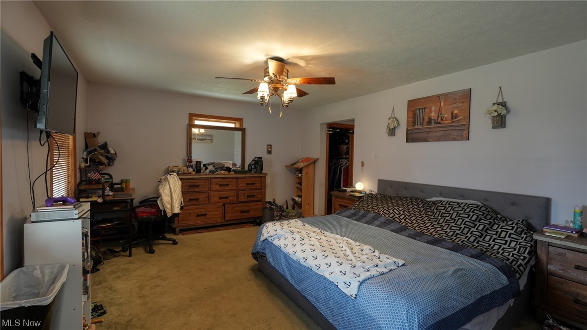 3752 Holmes Road Cambridge, OH 43725 - Photo 18 of 50 Bedroom featuring light colored carpet and ceiling fan