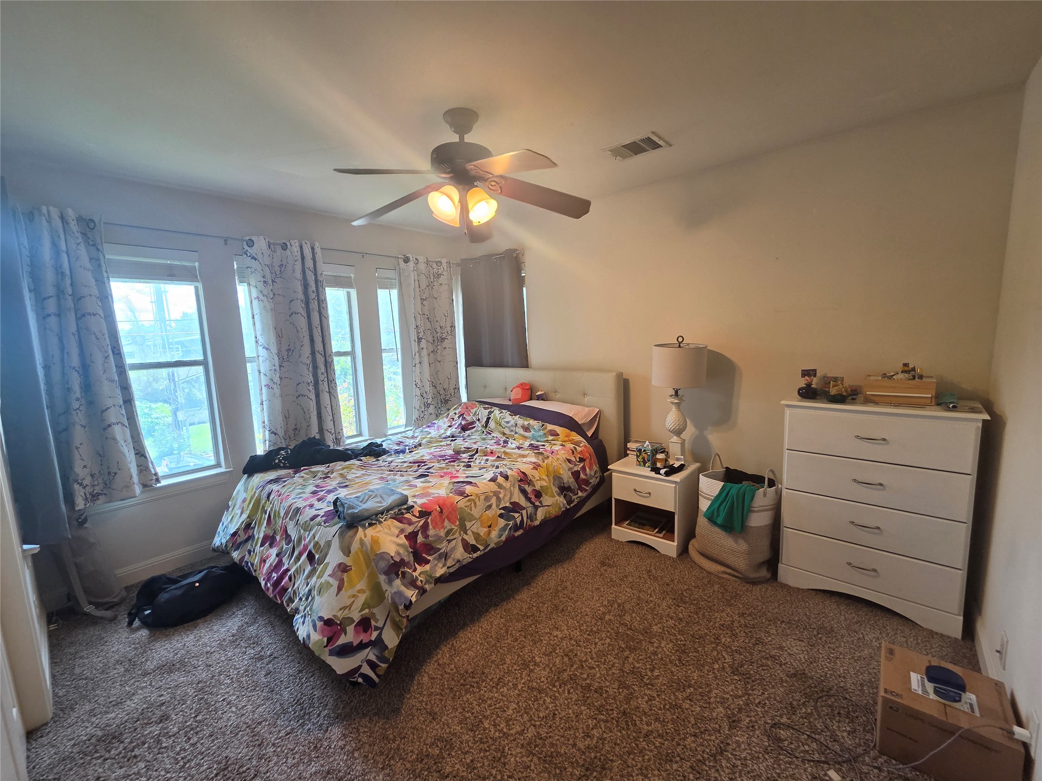 408 West Croslin Street Austin, TX 78752 - Photo 23 of 29 Well-lit sleeping quarters featuring soft carpet and multiple windows.