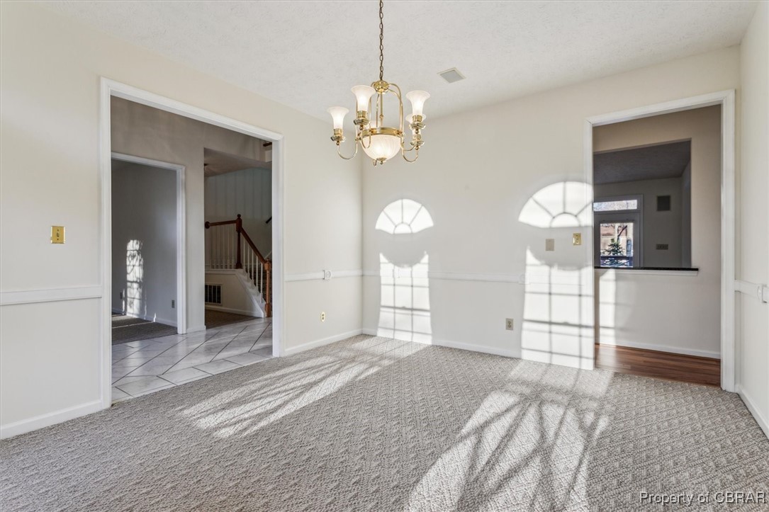 1318 Showalter Road Yorktown, VA 23692 - Photo 30 of 47 Carpeted empty room featuring a notable chandelier