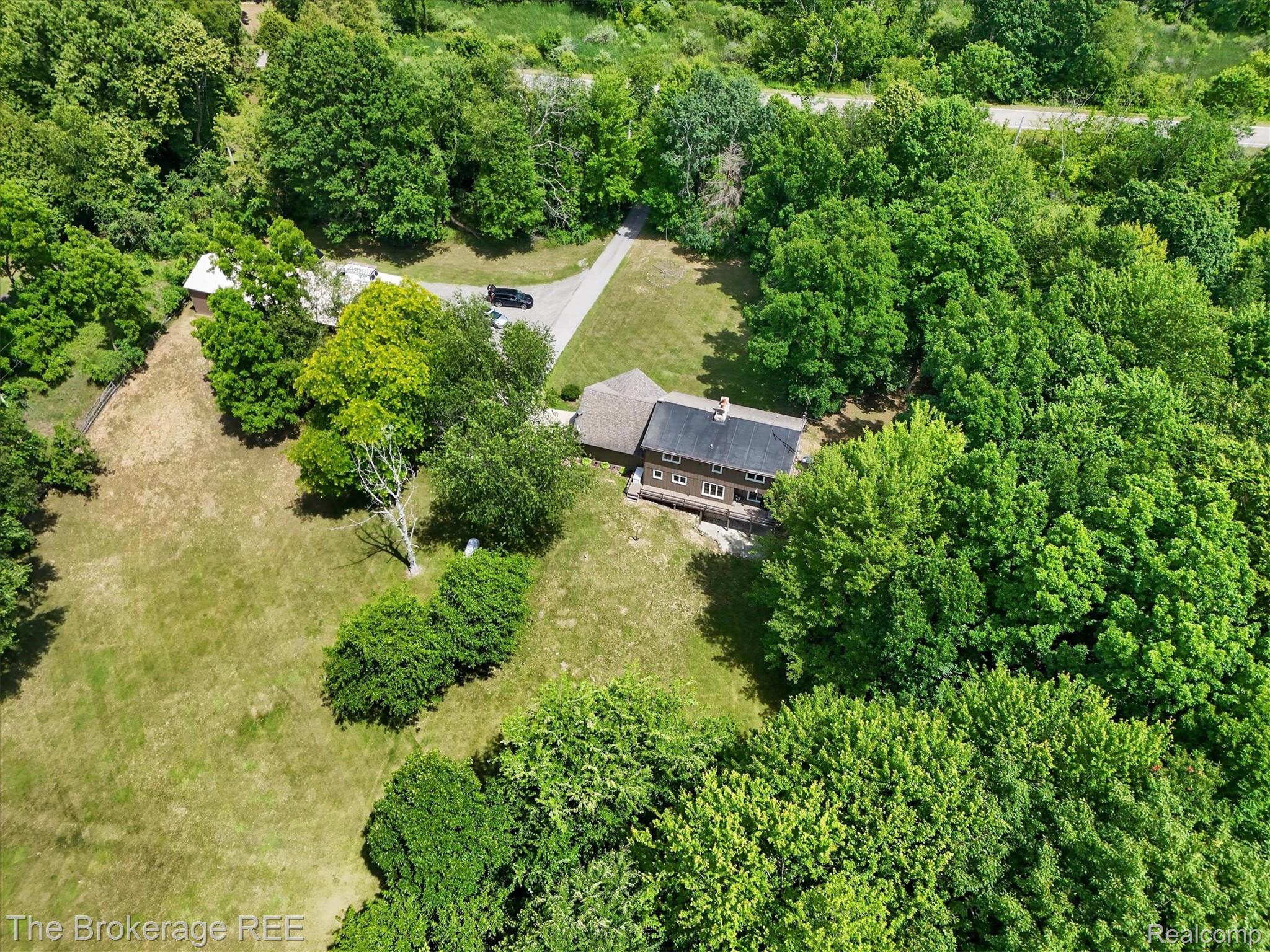 13269 North Genesee Road Clio, MI 48420 - Photo 57 of 67 Expansive property featuring a brown multi-story residence with a dark roof and multiple windows
