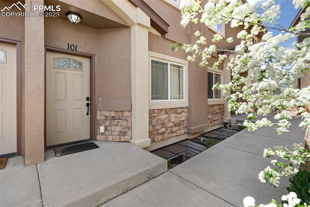 a view of a brick house with a tree