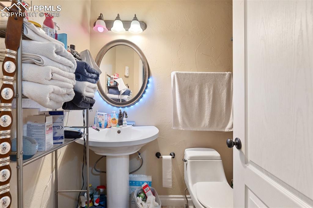 1510 York Road, Unit 101 Colorado Springs, CO 80918 - Photo 11 of 12 a bathroom with a sink mirror and toilet