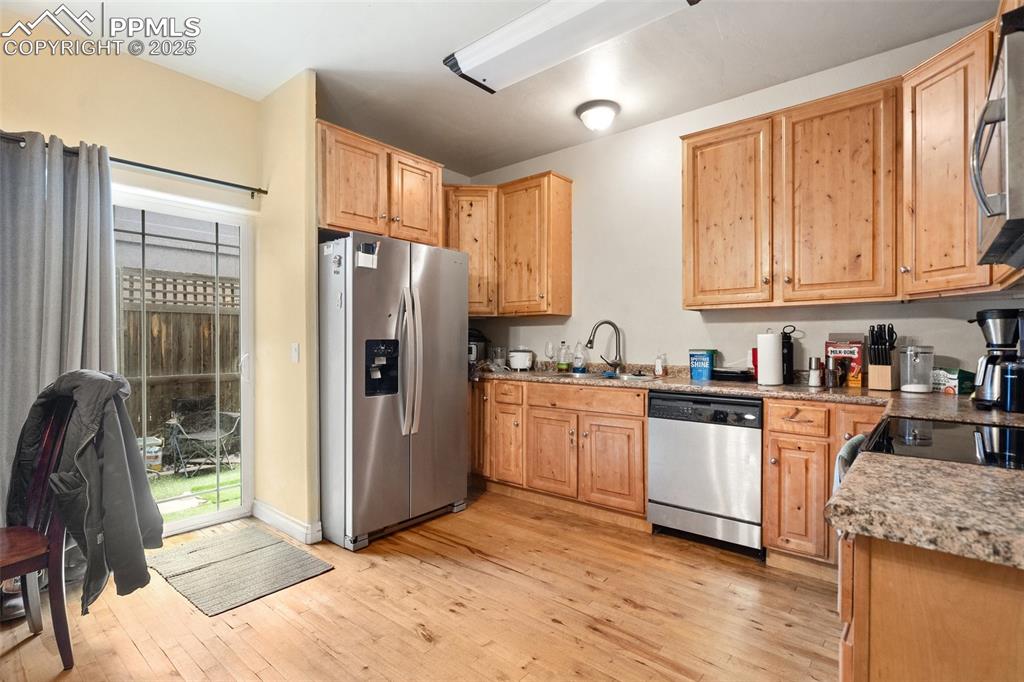 1510 York Road, Unit 101 Colorado Springs, CO 80918 - Photo 5 of 12 a kitchen with granite countertop a refrigerator stove top oven and sink