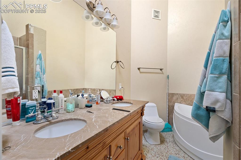 1510 York Road, Unit 101 Colorado Springs, CO 80918 - Photo 9 of 12 a bathroom with a granite countertop sink and a mirror