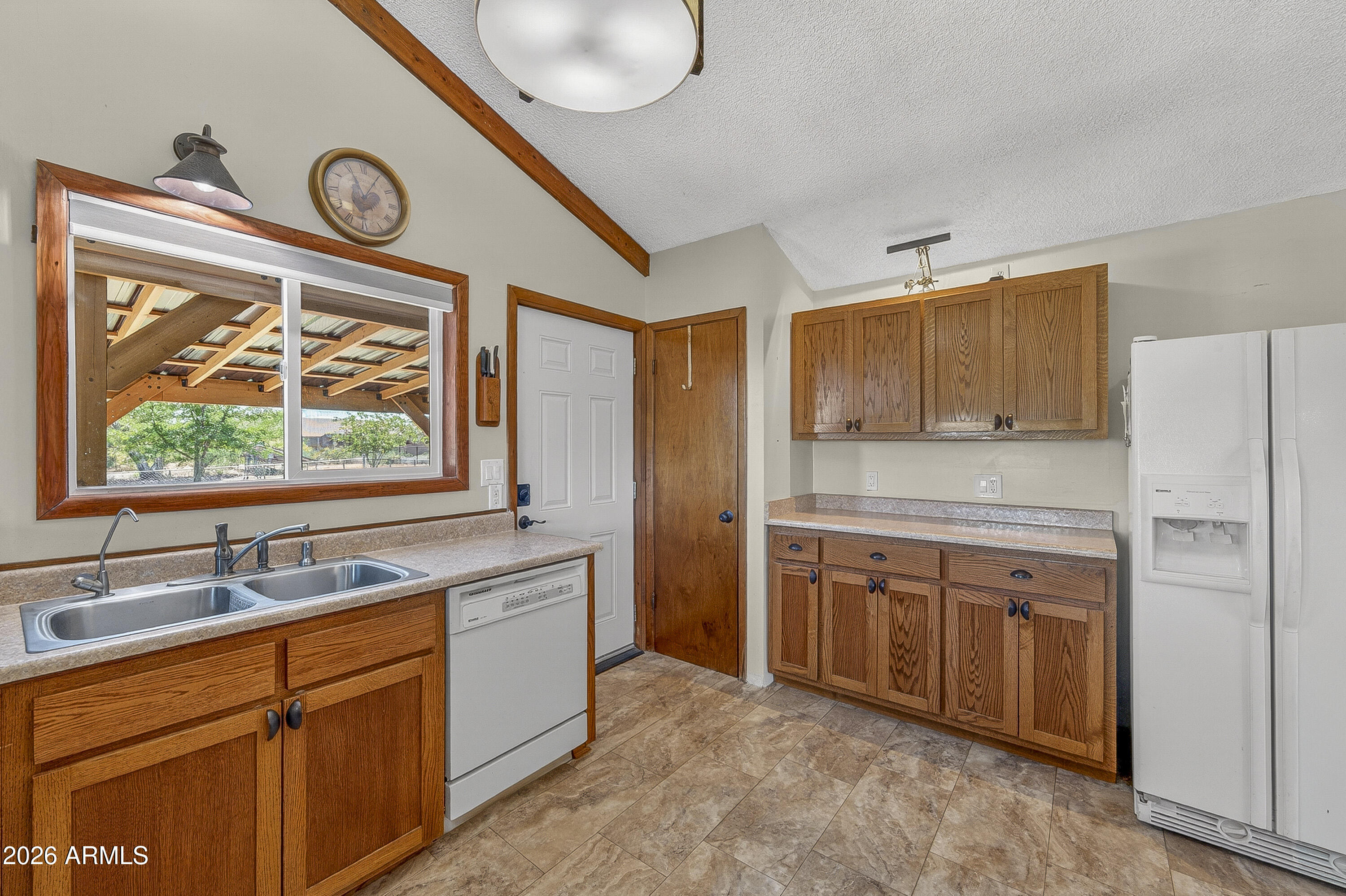 633 Oasis Road Camp Verde, AZ 86322 - Photo 45 of 50 a kitchen with stainless steel appliances granite countertop a stove a sink and a refrigerator