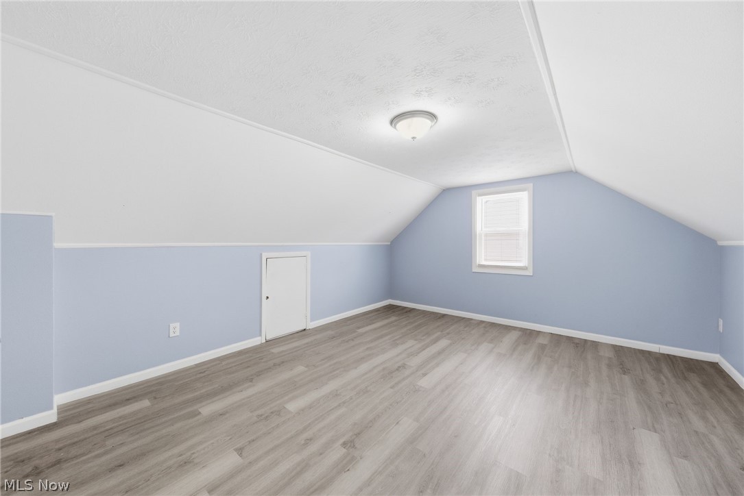 20705 Hansen Road Maple Heights, OH 44137 - Photo 17 of 24 Additional living space with light wood finished floors and a textured ceiling