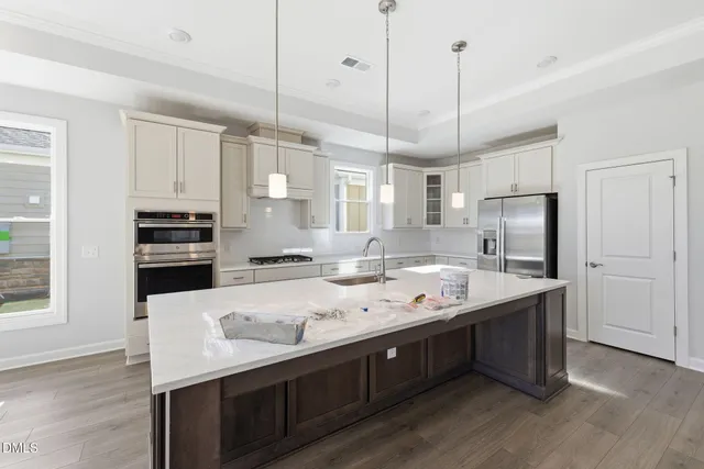 a kitchen with kitchen island a sink stainless steel appliances and cabinets