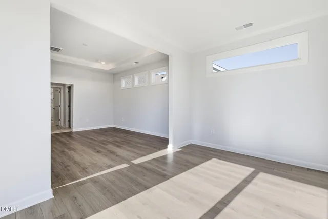 a bathroom with a double vanity sink mirror and next to a window