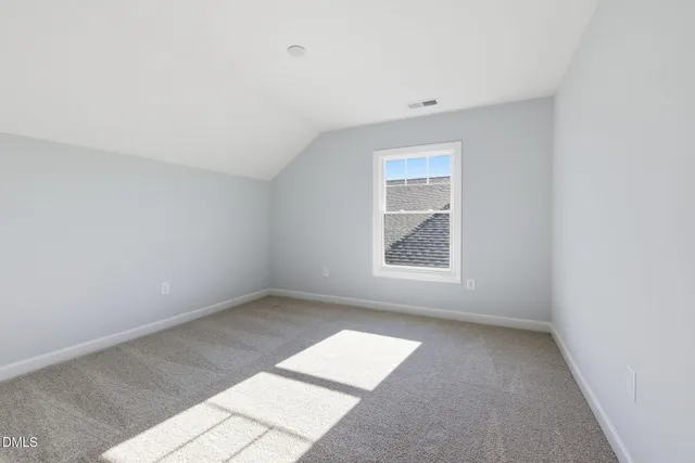 a view of a large room with wooden floor and iron stairs