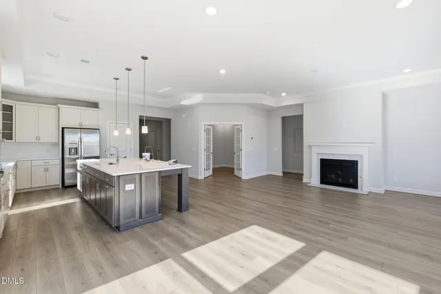 a kitchen with stainless steel appliances a sink cabinets and wooden floor