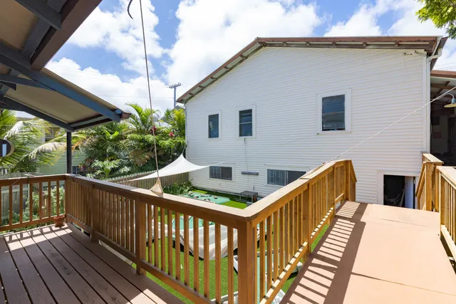 a view of a house with wooden deck