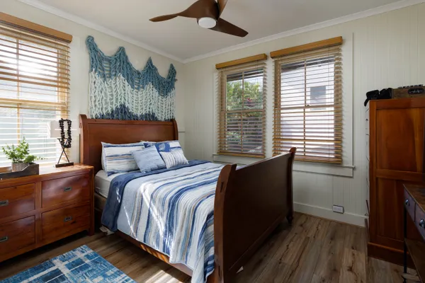 a bed sitting in a bedroom next to a window