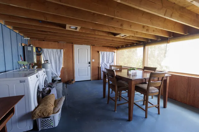 a view of a dining room with furniture and chandelier