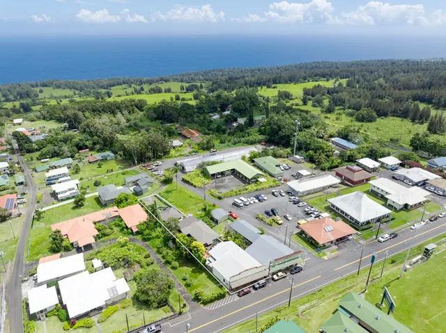 an aerial view of residential houses with outdoor space and street view