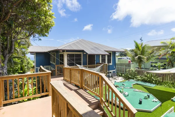 a view of house with swimming pool and outdoor seating