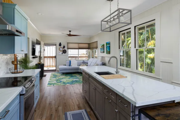 a kitchen with sink cabinets and wooden floor