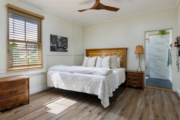 a bedroom with a bed and a window