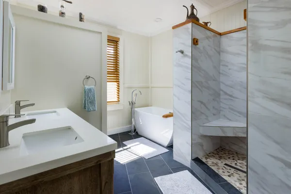 a bathroom with a sink a toilet and shower