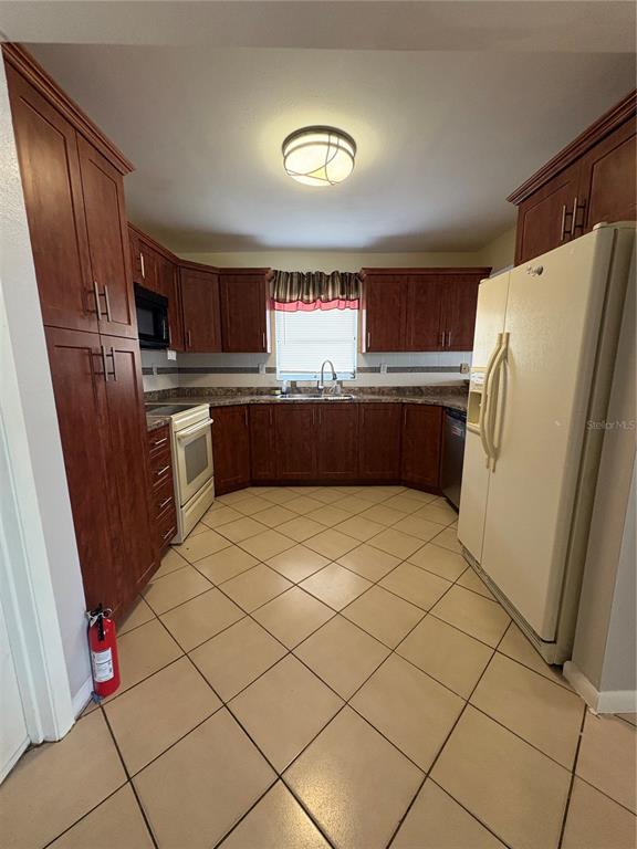4027 Bianca Street Sebring, FL 33872 - Photo 12 of 22 a kitchen with stainless steel appliances granite countertop a refrigerator and a sink