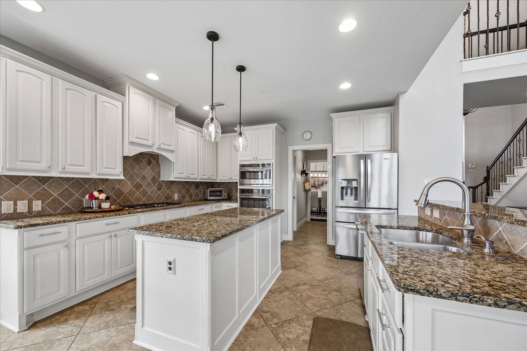 1616 Hewitt Drive Houston, TX 77018 - Photo 9 of 44 Chef inspired kitchen features granite countertops, abundant cabinetry, and a spacious island ideal for meal prep and casual seating.
