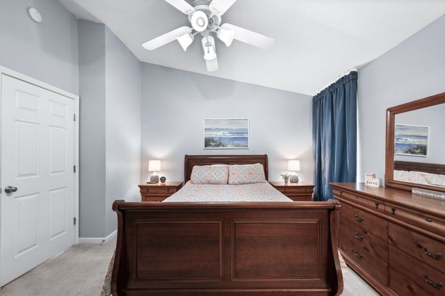 a bedroom with a large bed and a large mirror