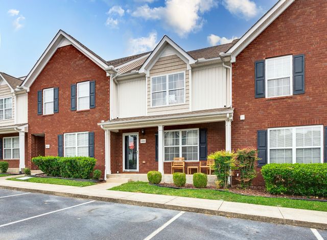 a front view of a house with garden and porch