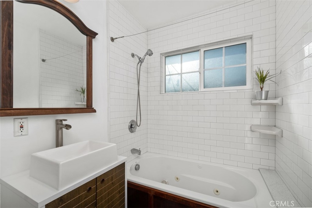 5117 Vincent Avenue Eagle Rock, CA 90041 - Photo 13 of 46 a bathroom with a sink a mirror and a shower