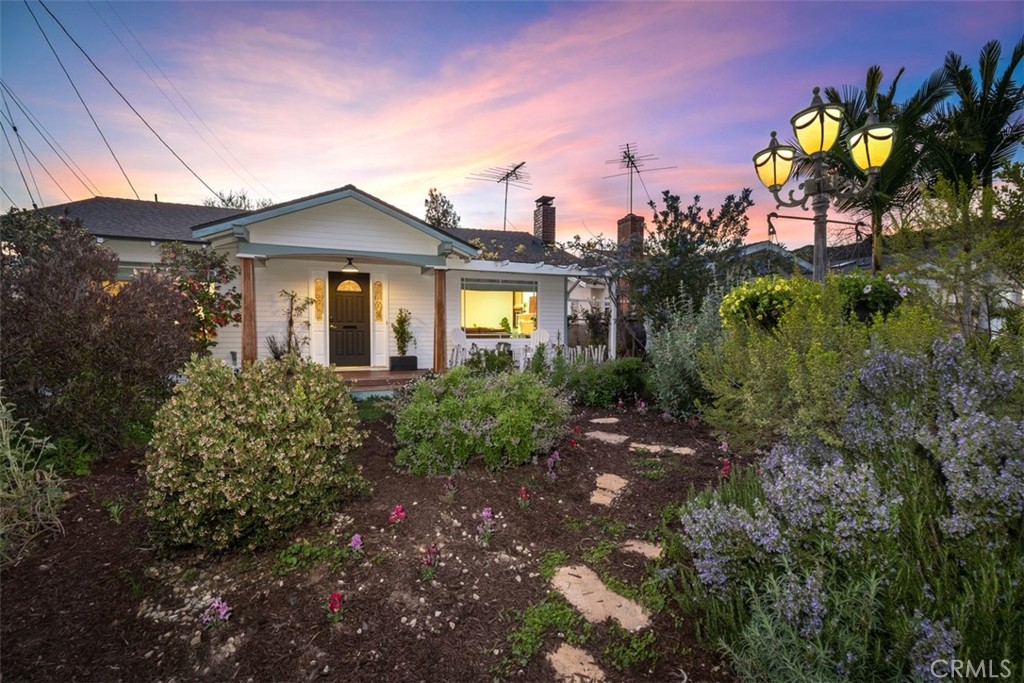 5117 Vincent Avenue Eagle Rock, CA 90041 - Photo 36 of 46 a front view of a house with a yard and potted plants