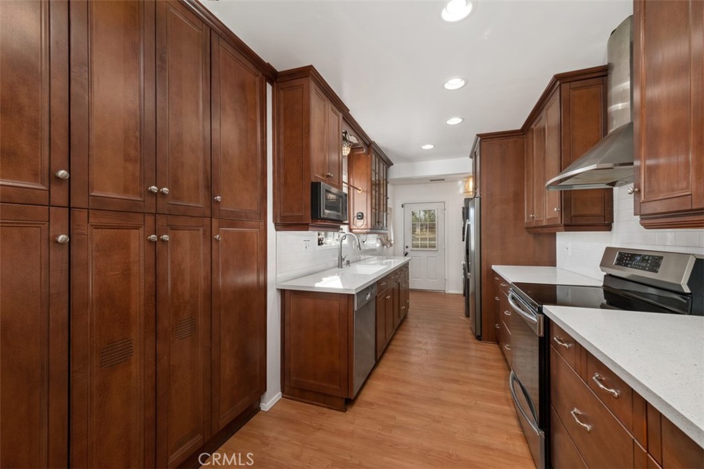 5117 Vincent Avenue Eagle Rock, CA 90041 - Photo 8 of 46 a kitchen with a sink stainless steel appliances wooden cabinets and a sink
