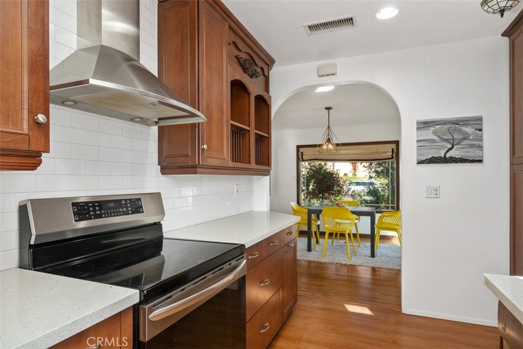 5117 Vincent Avenue Eagle Rock, CA 90041 - Photo 9 of 46 a kitchen with a table chairs and a stove