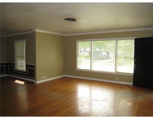 616 Sorrell Street Corpus Christi, TX 78404 - Photo 2 of 10 an empty room with wooden floor and windows