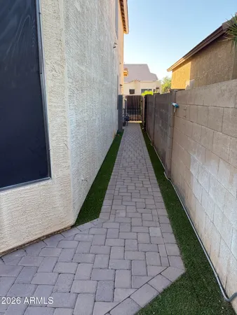 a view of a pathway both side of house