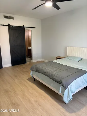 a bedroom with a bed and dresser