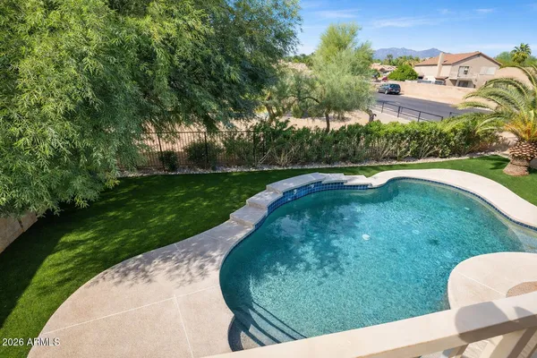 a view of a swimming pool with a yard
