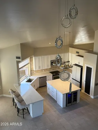 a living room with furniture a dining table and chairs with kitchen view